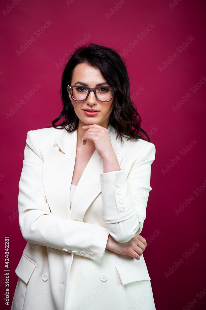 Girl in white suit with loose dry hair and make-up posing on a background. Fashion style body length studio portrait. Elegant fashionable woman Girl in white suit with loose dry hair and make-up posing on a background. Fashion style body length studio portrait. Elegant fashionable woman