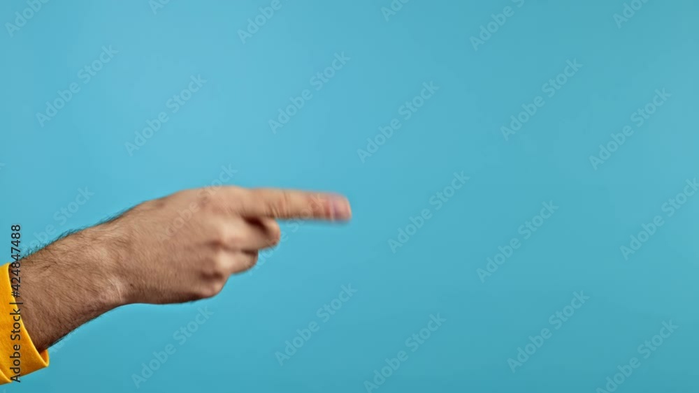Hands of man, he indicates with finger on right side copy space. Guy pointing, presenting and showing something isolated on blue background. Hands of man, he indicates with finger on right side copy space. Guy pointing, presenting and showing something isolated on blue background.
