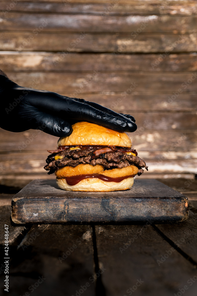 hand smashing onion and bacon hamburger hand smashing onion and bacon hamburger