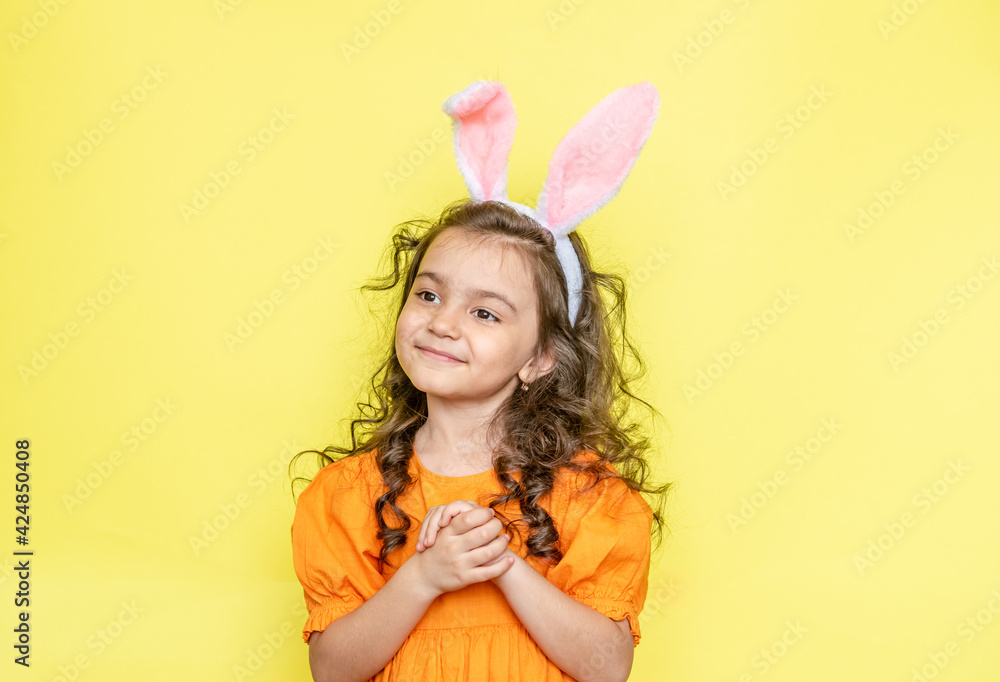 funny happy girl with easter bunny ears on yellow background funny happy girl with easter bunny ears on yellow background