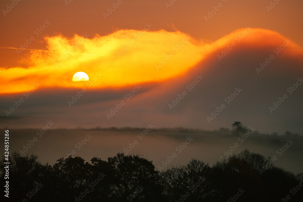 Huge orange sun in autumn morning, foggy scenery, wallpaper, edit space Huge orange sun in autumn morning, foggy scenery, wallpaper, edit space