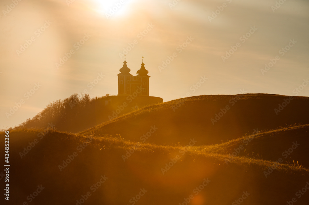 Obraz premium silhouette of Calvary church in Banska Stiavnica, Slovakia. Sunset light