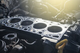 Cylinder head gasket replacement. Repair of a turbocharged diesel engine in a car workshop. Blur effect.