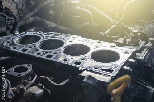 Cylinder head gasket replacement. Repair of a turbocharged diesel engine in a car workshop. Blur effect. photo