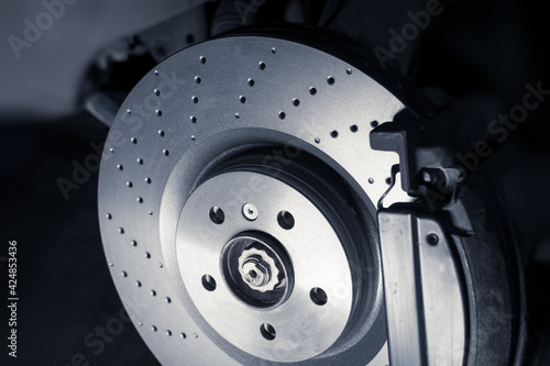 Konstfotografi Installation of new perforated brake discs and pads on a modern auto in a car workshop