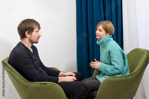 A young man, in consultation with a psychologist, shares his problems in the office. Crisis, depression, unemployment