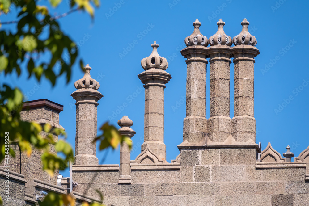 The walls and towers of the old palace on the background of a blue sky