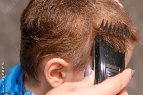 The hairdresser does the boy's hair. Children's haircuts are mandatory for all children