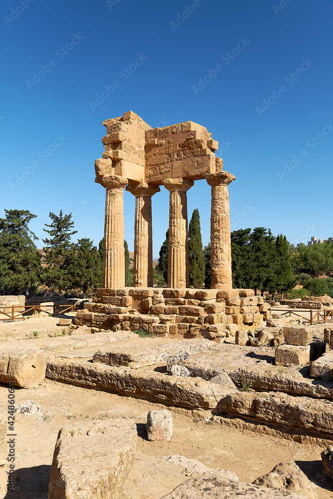 The temple of Castor and Pollux, Dioscuri brothers. It has only four columns left and has become the symbol of Agrigento. Valley of the Temples in Agrigento, Sicily, Italy.