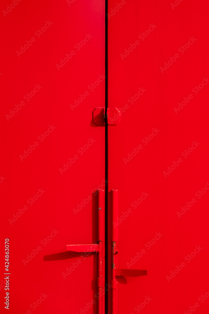 Metal red door with padlock and swing bolt Metal red door with padlock and swing bolt
