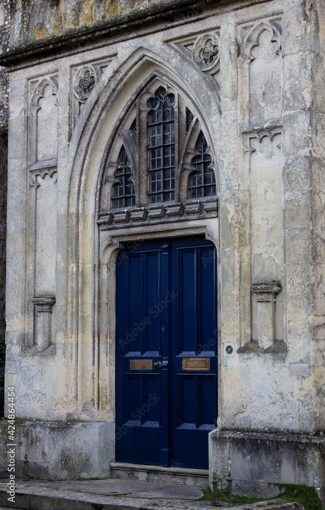 The blue wood doors of a British church somewhere in England, UK