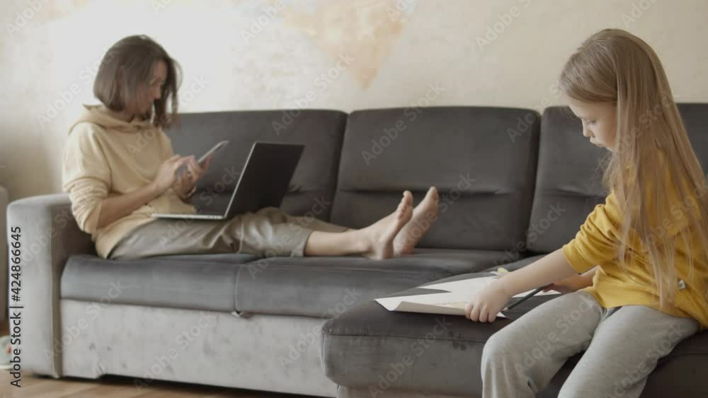 Woman Working From Home Close To Her Daughter Woman Working From Home Close To Her Daughter
