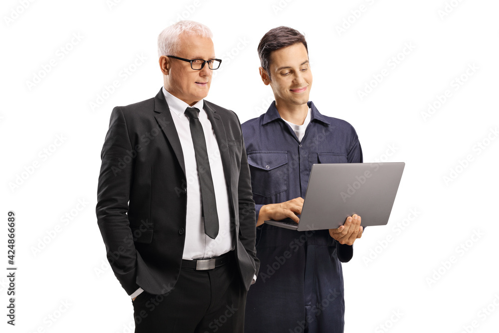 Mechanic and a mature businessman looking at a laptop