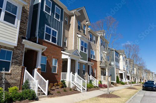 A row of attached residential suburban townhomes