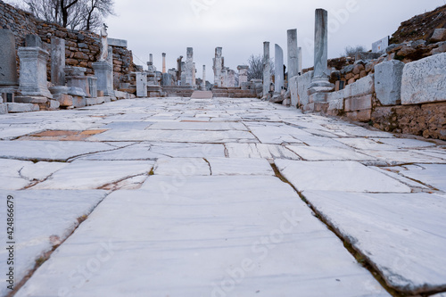 Hercules Gate at the end of Curetes Street and statues in Ephesus ruins, historical ancient Roman archaeological sites in eastern Mediterranean Ionia region. Selcuk, Izmir, Turkey - 03.09.2021: