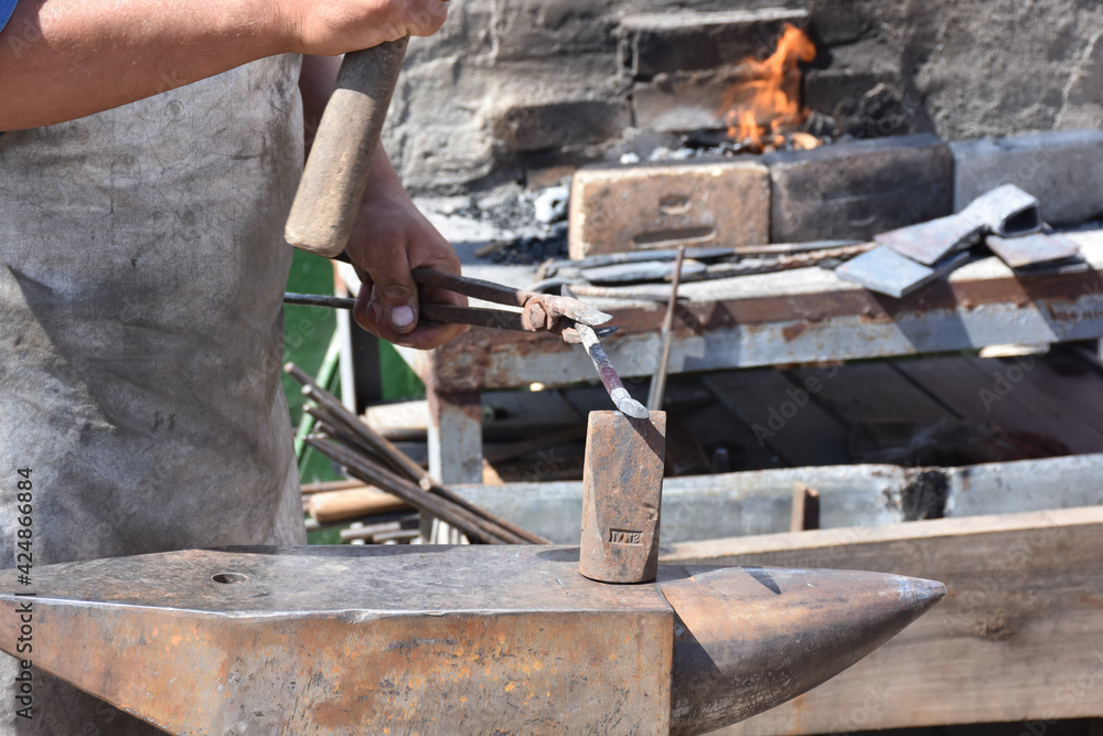Blacksmith forged ironsmith. traditional hammer beating. Medieval blacksmith. Horseshoe workspace made with the medieval blacksmith method. Blacksmith forged ironsmith. traditional hammer beating. Medieval blacksmith. Horseshoe workspace made with the medieval blacksmith method.