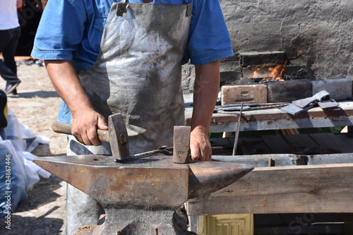 Blacksmith forged ironsmith. traditional hammer beating. Medieval blacksmith. Horseshoe workspace made with the medieval blacksmith method