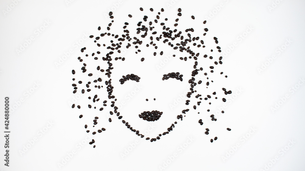 Face of a contented woman made from chocolate seeds. Girl closed her eyes in pleasure. Face of a contented woman made from chocolate seeds. Girl closed her eyes in pleasure.