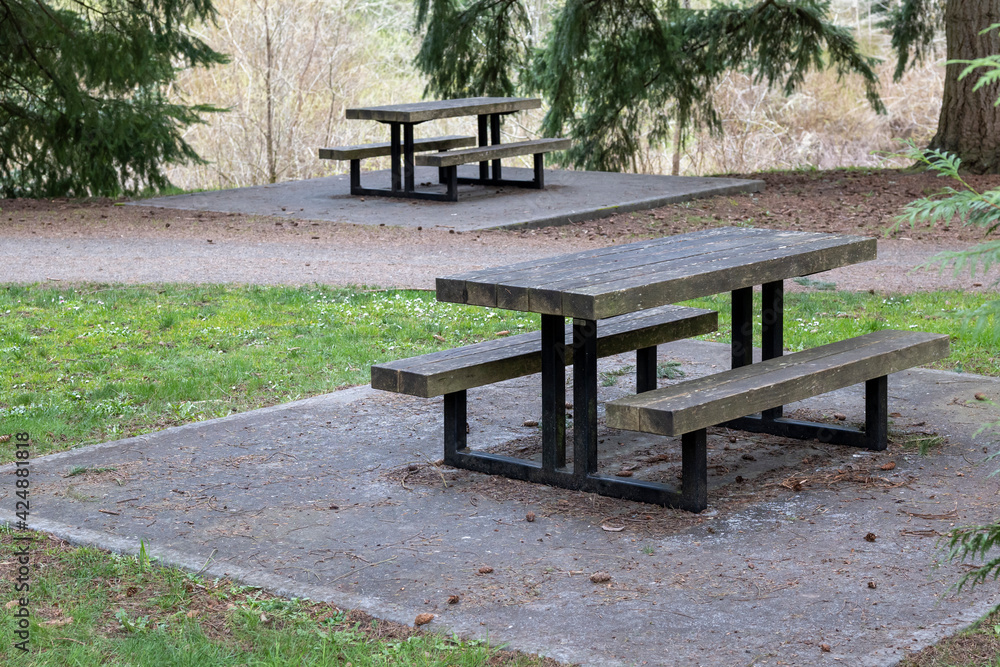 Picnic tables on concrete slabs at public park