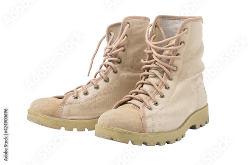 Old sandy beige tracking boots on white background. Isolated.