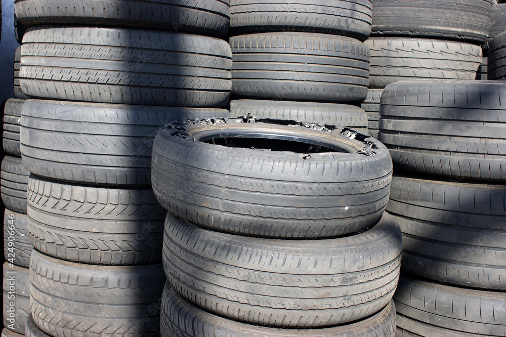 Old tires outside garage ready for recycling Old tires outside garage ready for recycling