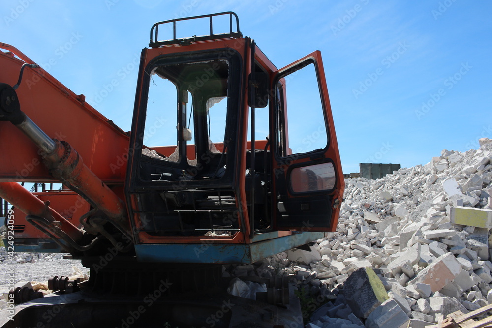 broken tractor glass in the cab unnecessary rusty excavator at the scrap yard broken tractor glass in the cab unnecessary rusty excavator at the scrap yard