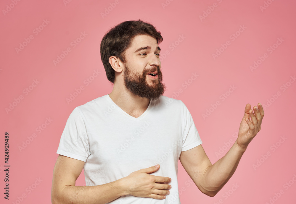 Emotional man gesturing with his hands on a pink background cropped view Emotional man gesturing with his hands on a pink background cropped view