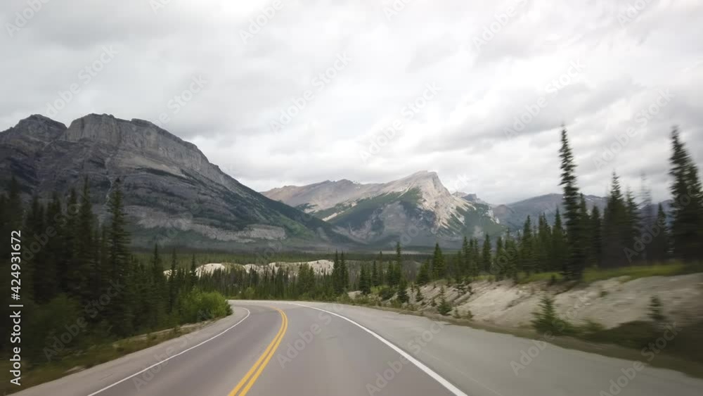 Driving North Towards Jasper from Banff National Park During Cloudy Summer Day Driving North Towards Jasper from Banff National Park During Cloudy Summer Day