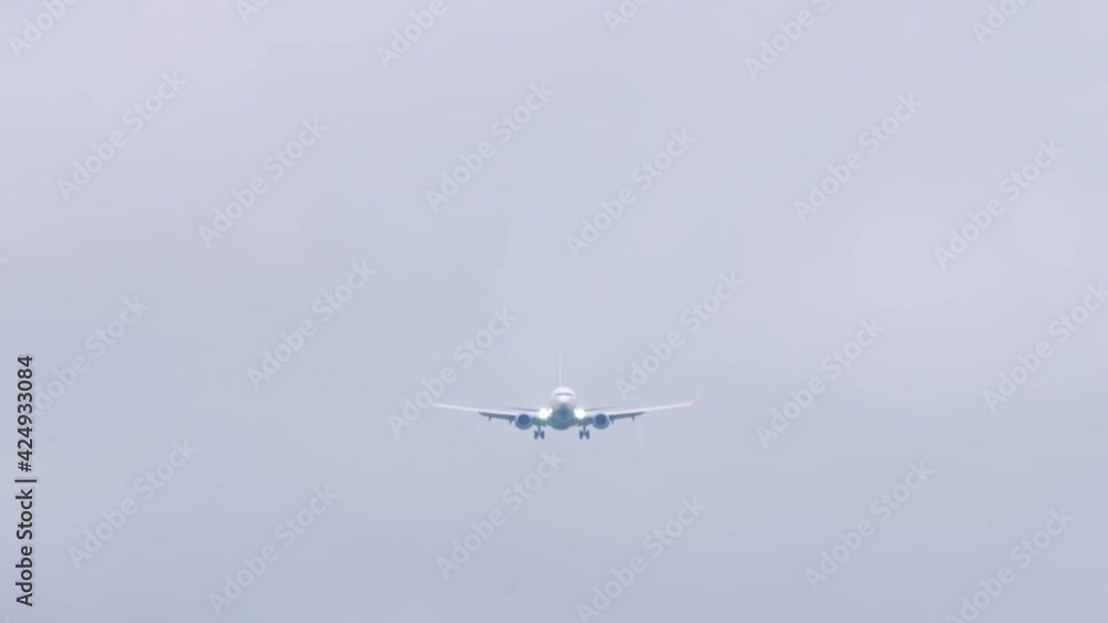 Airplane silhouette in the gray sky Airplane silhouette in the gray sky