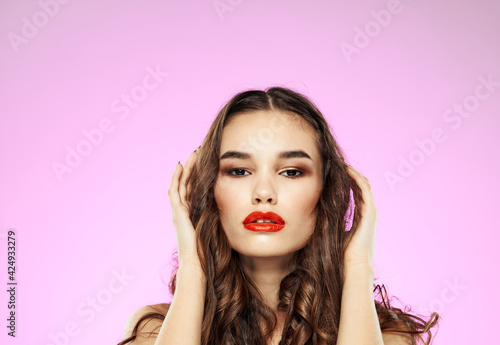 Sexy woman model with red lips brunette model and pink background