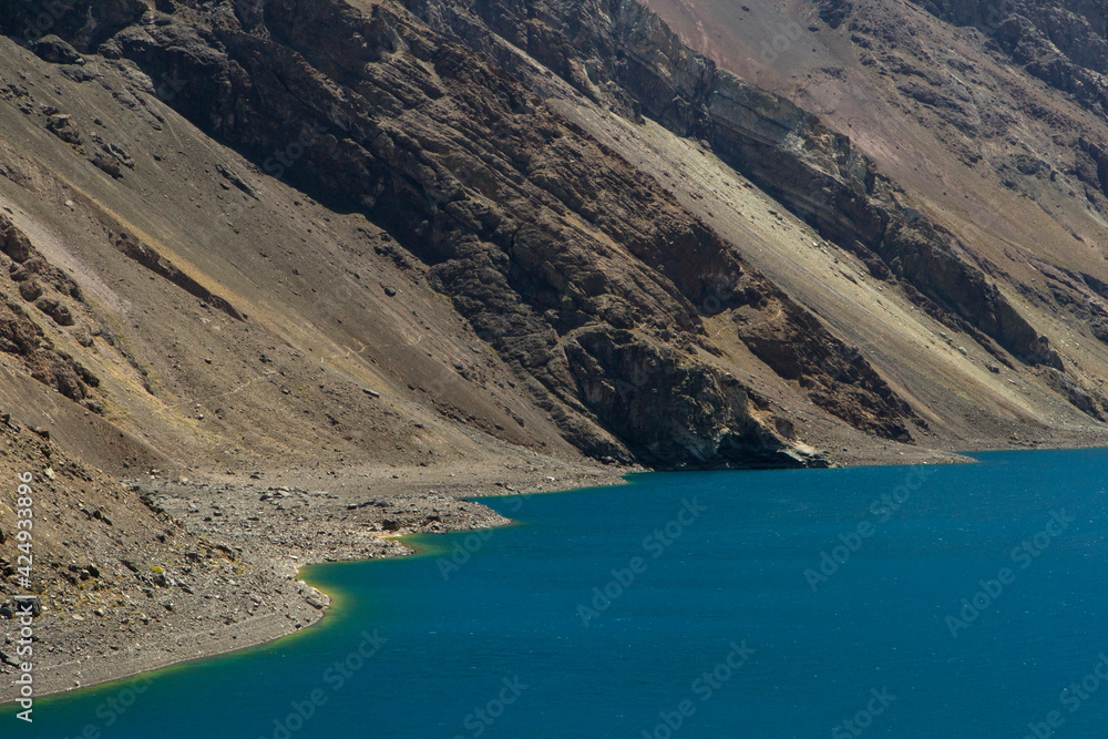 The turquoise color water laker high in the Andes cordillera. The glacier water lake called Inca Lagoon and arid mountains in Portillo, Chile.