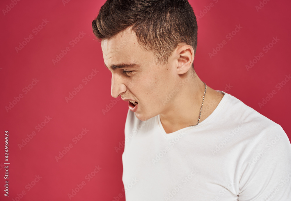 man in white t-shirt close-up red background dissatisfaction man in white t-shirt close-up red background dissatisfaction