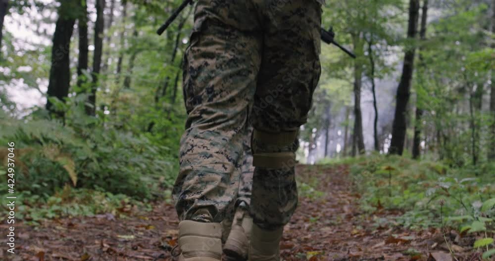 Military action in dense forest rear view Military action in dense forest rear view