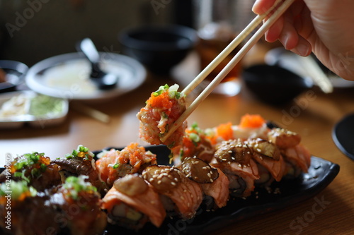 Overhead japanese sushi food. Eating sushi set with chopsticks on restaurant.