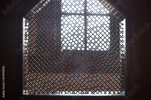 old priest inside the wooden confessional in a Christian church. photo