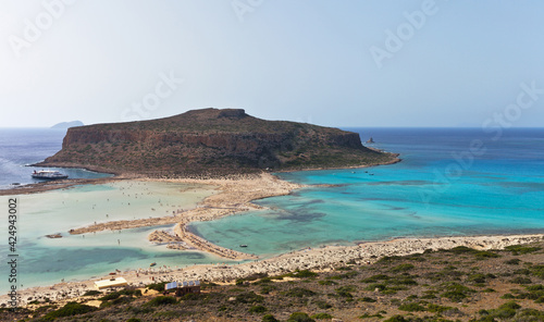 Top view on famous Balos beach on the west coast of the Greek island of Crete with amazing pink sand and a shallow bays with azure water popular with tourists. Summer travel and seaside rest