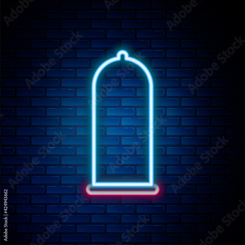 Glowing neon line Condom safe sex icon isolated on brick wall background. Safe love symbol. Contraceptive method for male. Colorful outline concept. Vector