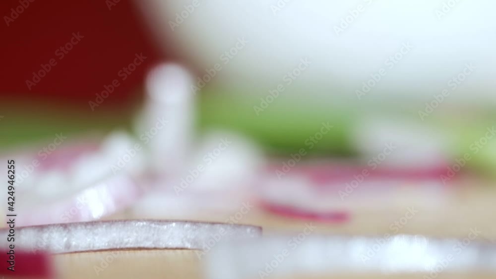 A man is slicing and preparing red onion rings in 4K. Concept of separating sliced onion rings for a Greek Salad. A man is slicing and preparing red onion rings in 4K. Concept of separating sliced onion rings for a Greek Salad.