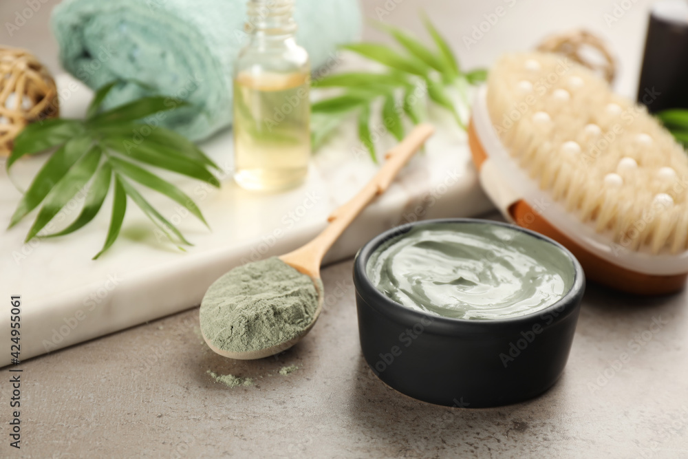 Cosmetic product for spa body wraps on light grey stone background Cosmetic product for spa body wraps on light grey stone background