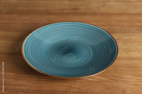 Elegant new empty plate on wooden table
