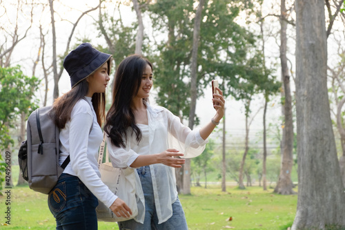 Young woman taking picture of a park in the university. photo