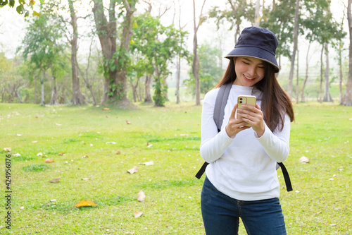 Young woman taking picture of a park in the university. photo