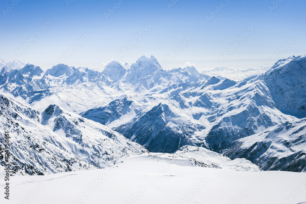 Snowy winter Greater Caucasus mountains at sunny day. View from ski slope Elbrus, Kabardino-Balkaria, Russia