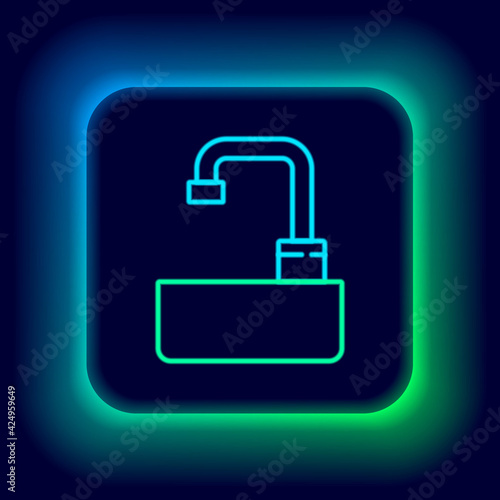 Glowing neon line Washbasin with water tap icon isolated on black background. Colorful outline concept. Vector
