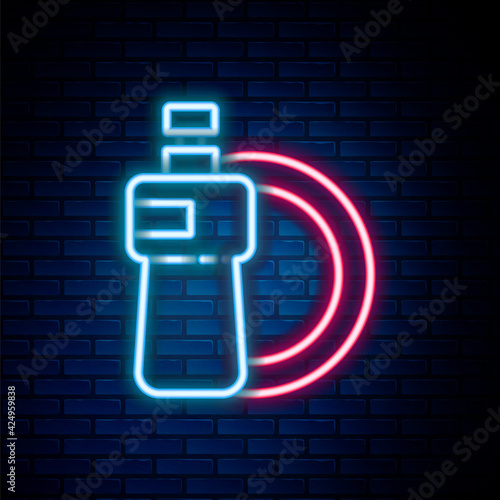 Glowing neon line Dishwashing liquid bottle and plate icon isolated on brick wall background. Liquid detergent for washing dishes. Colorful outline concept. Vector