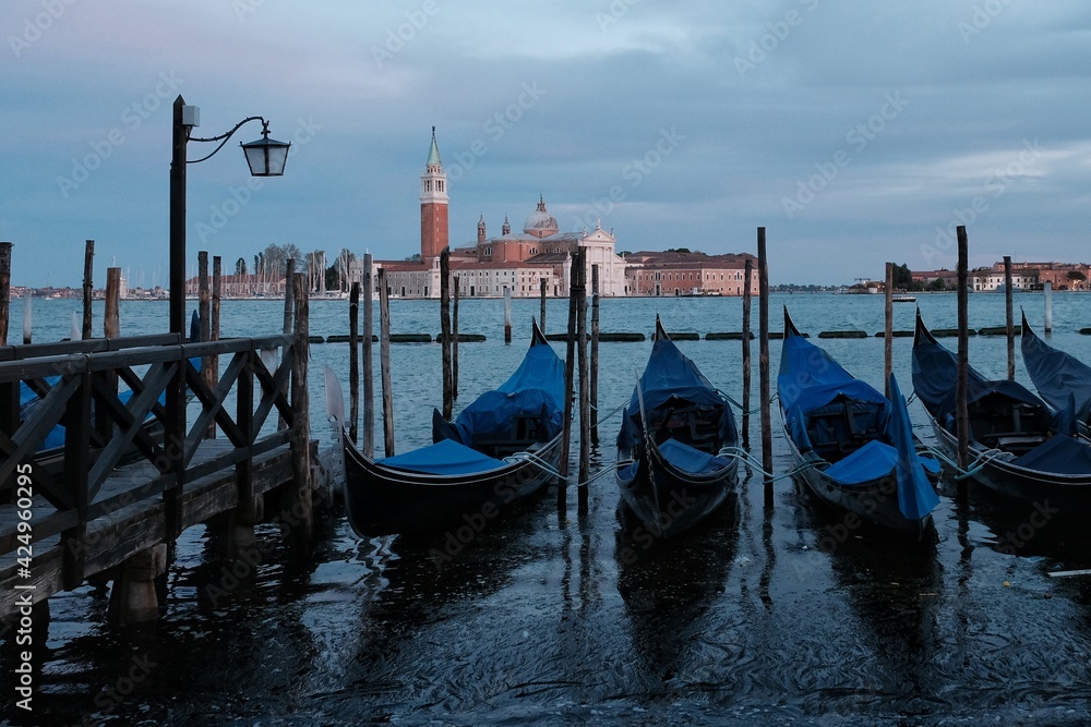 A variety of gondola just in front of Saint Mark's square and a cathedral church in the background in Venice Italy