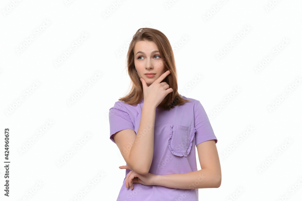 Portrait of cute thinking young woman holding arm on chin wear casual t shirt Portrait of cute thinking young woman holding arm on chin wear casual t shirt