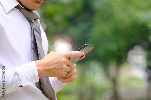 Businessman using a smartphone and working on technology concept