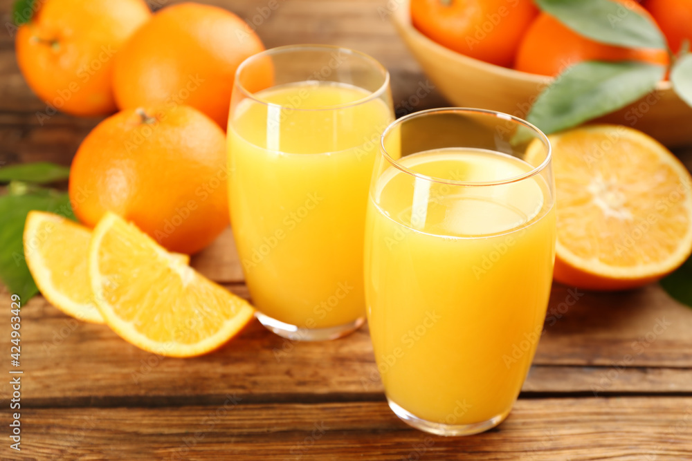 Orange juice and fresh fruits on wooden table Orange juice and fresh fruits on wooden table