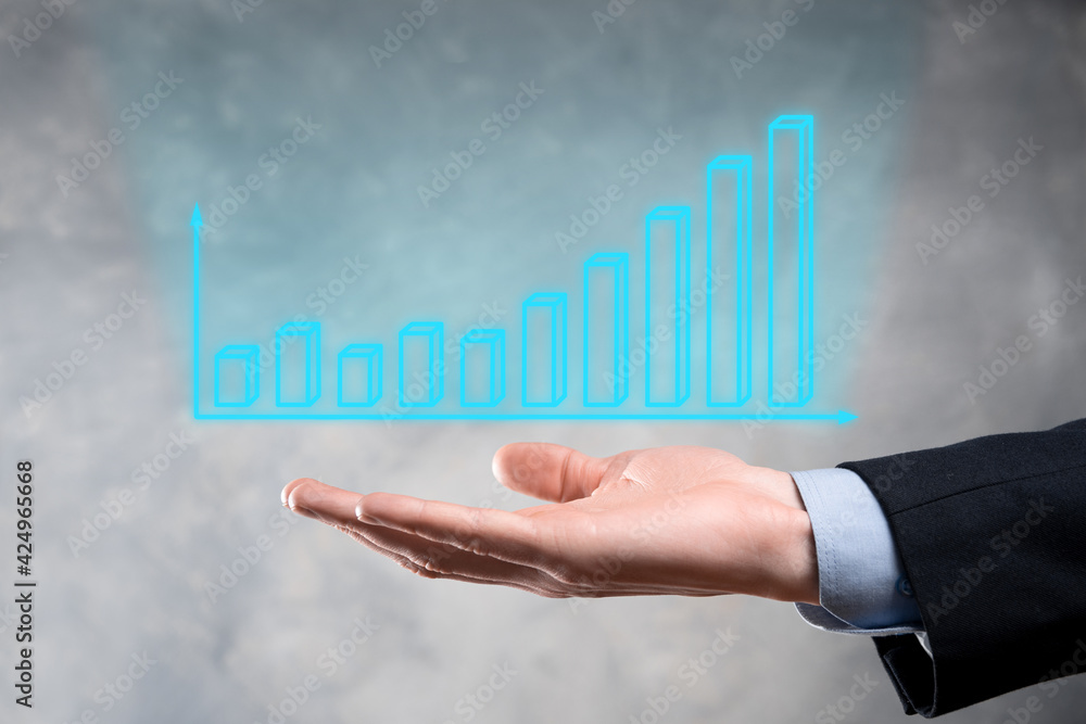 Businessman holding graph growth and increase of chart positive indicators in his business.Investment up concept.analyzing sales data and economic,strategy and planning, Digital marketing and stock Businessman holding graph growth and increase of chart positive indicators in his business.Investment up concept.analyzing sales data and economic,strategy and planning, Digital marketing and stock
